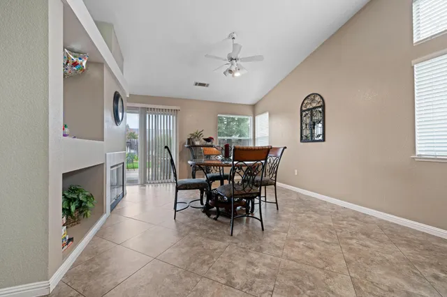 a view of a dining room with furniture and a window