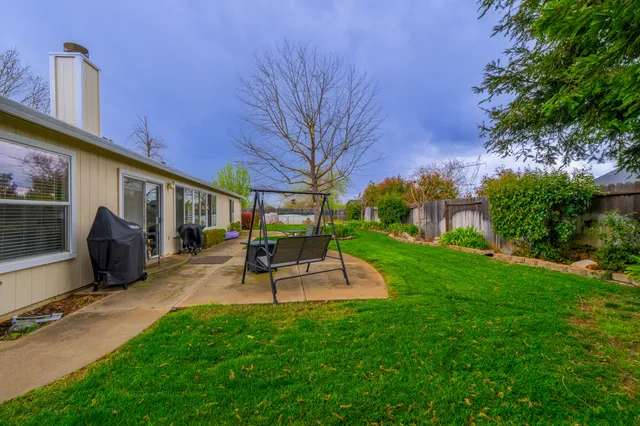 a view of a backyard with sitting area
