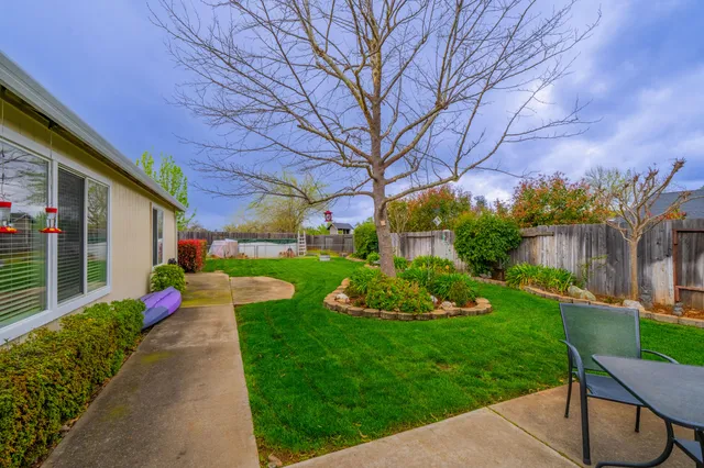 a front view of a house with a yard table and chairs