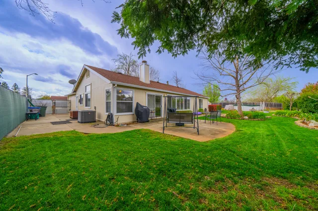 a view of a house with swimming pool and sitting area