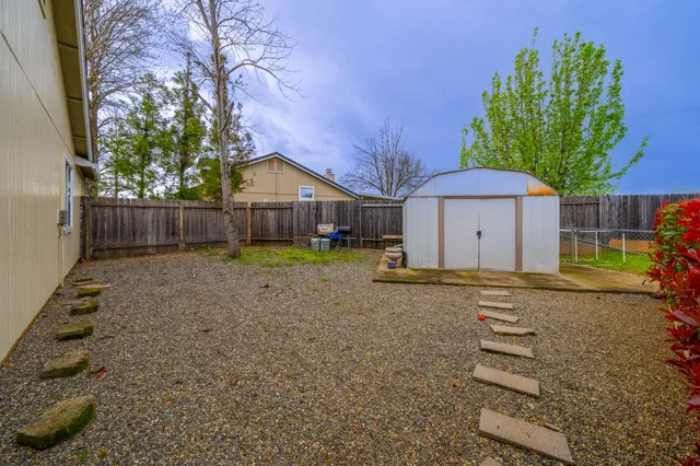 a backyard of a house with wooden fence