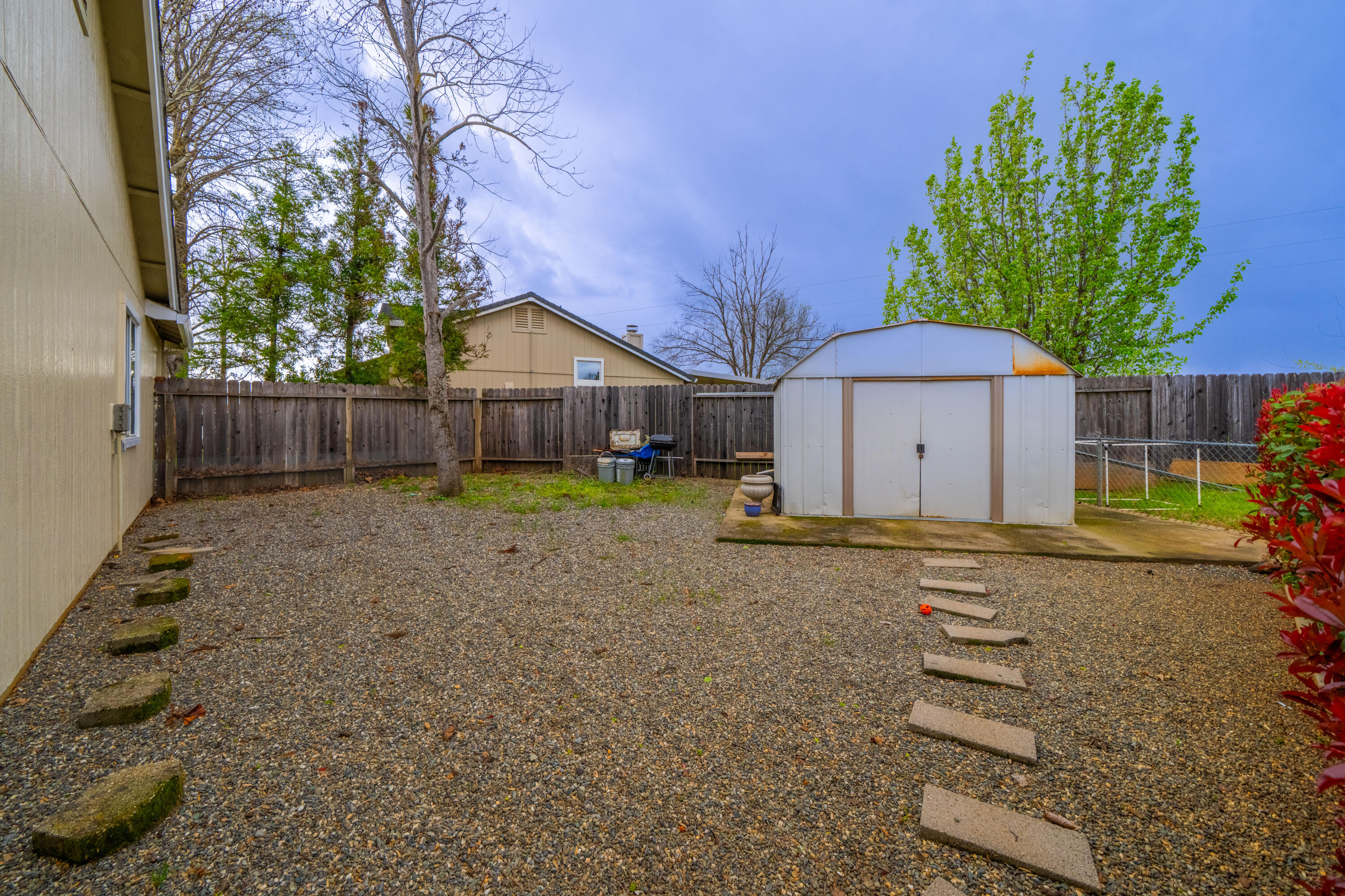 1959 Alexis Court Redding, CA 96002 - Photo 27 of 34 a backyard of a house with wooden fence