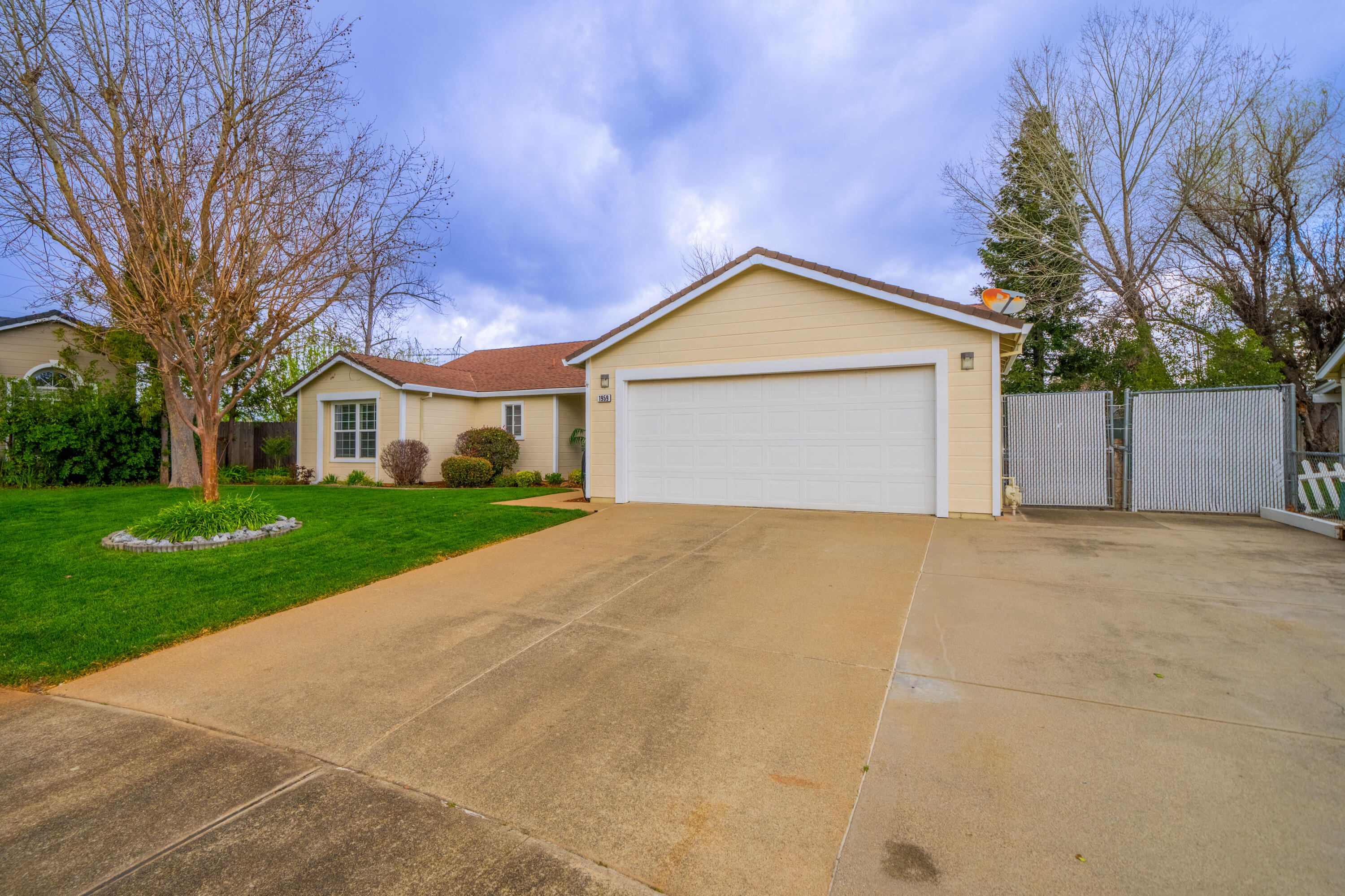 1959 Alexis Court Redding, CA 96002 - Photo 29 of 34 a front view of a house with a yard and garage