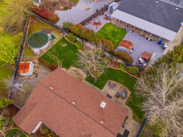 an aerial view of a house with a yard and garden
