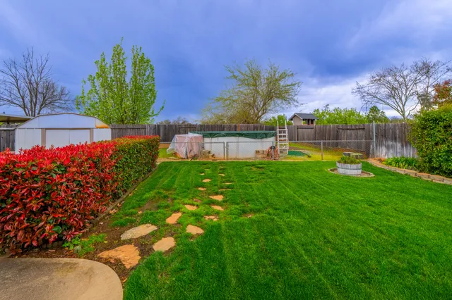 a view of a house with a backyard and a garden