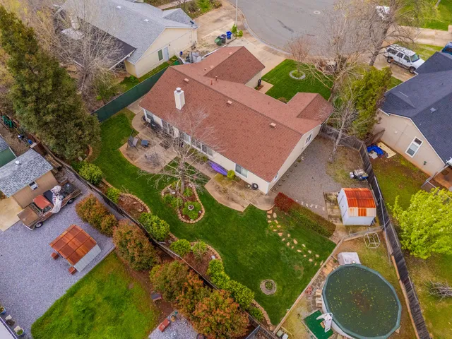 an aerial view of a house with a yard and lake view