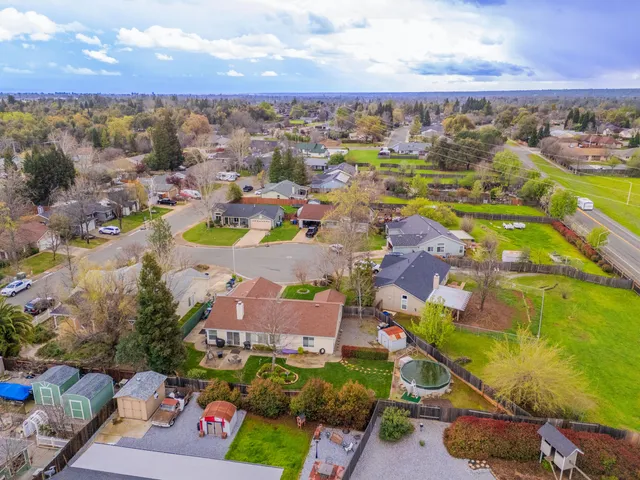an aerial view of residential houses with outdoor space