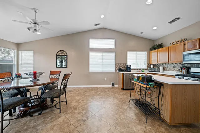 a view of a dining room with furniture and a kitchen