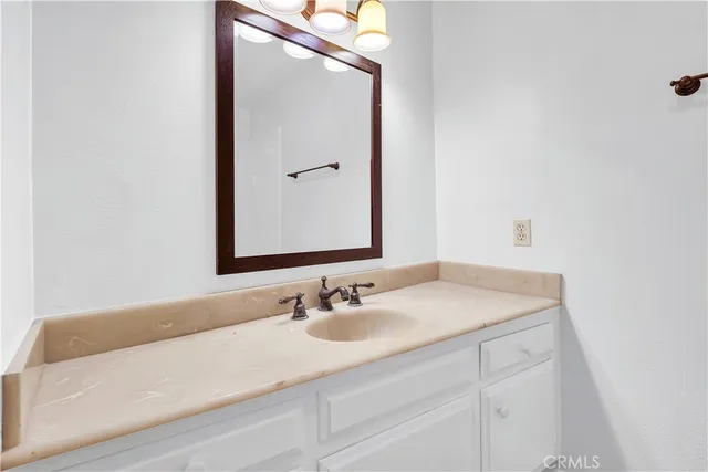 a bathroom with a sink vanity and a mirror