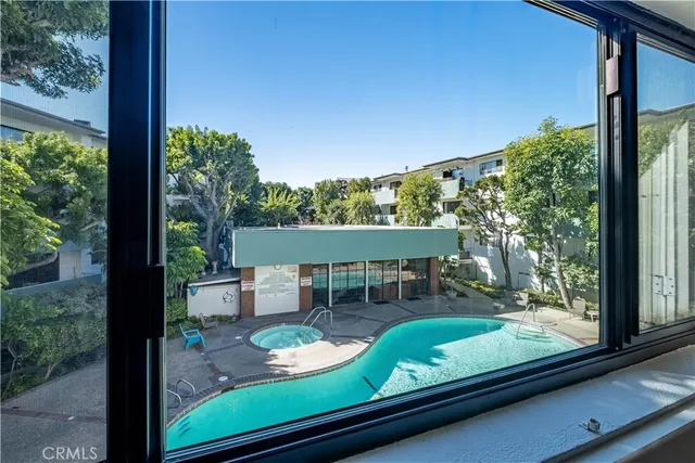 a view of a building with potted plants and a bench