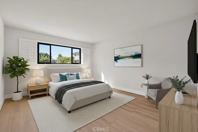 a bedroom with a bed window and potted plant