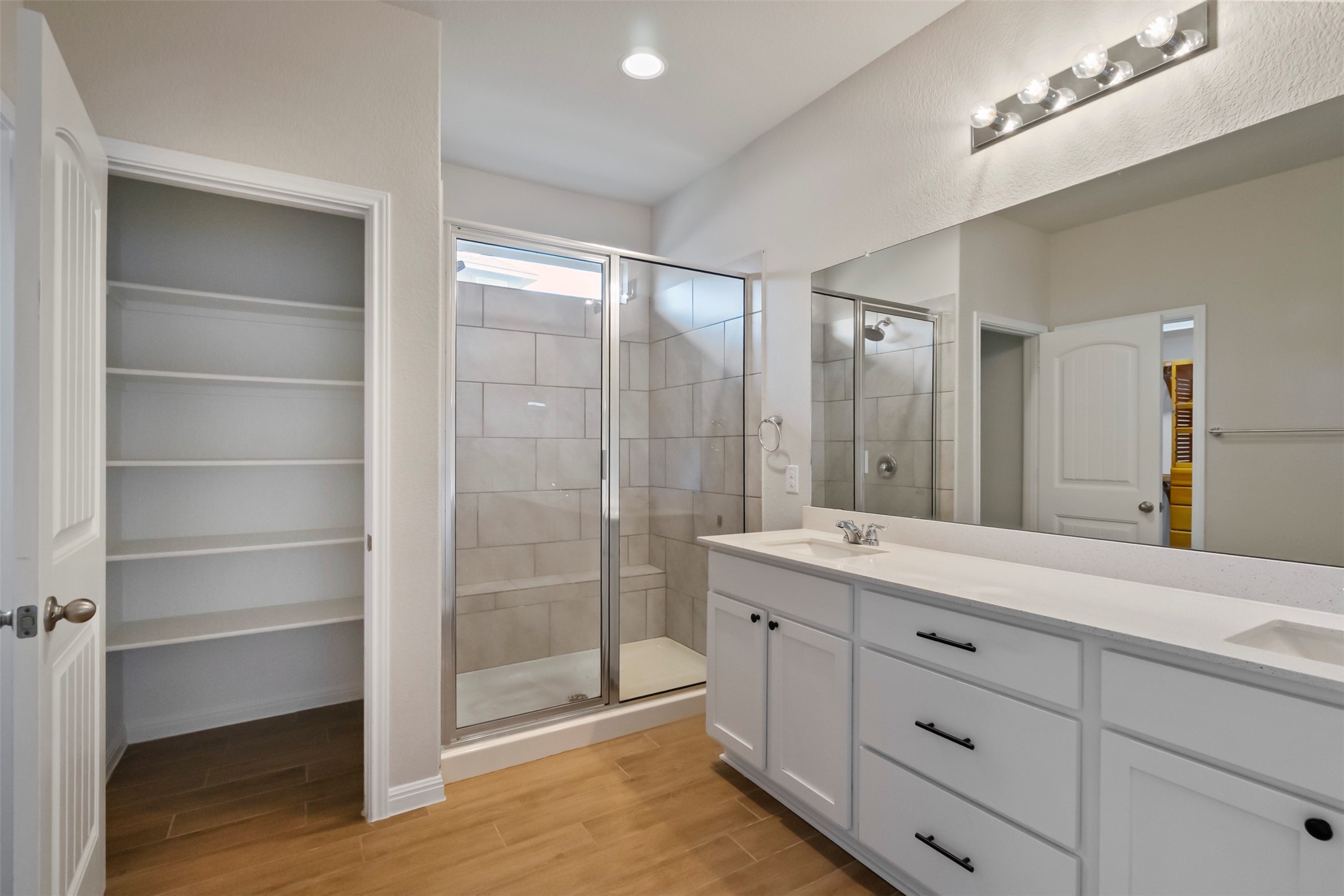 4125 Buffalo Ford Road Georgetown, TX 78628 - Photo 10 of 28 Bathroom featuring a shower stall, wood finished floors, and double vanity
