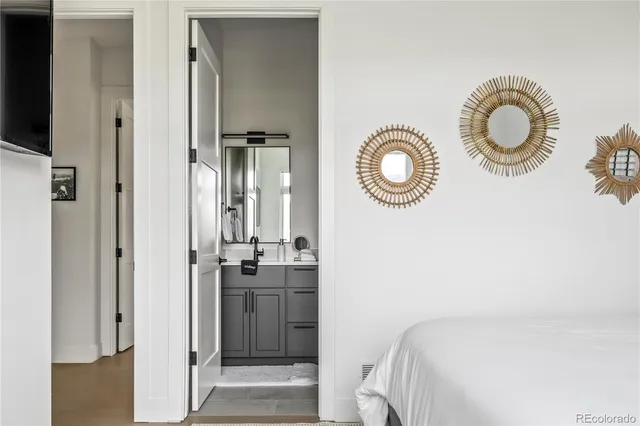 a bedroom with a bed and a chandelier