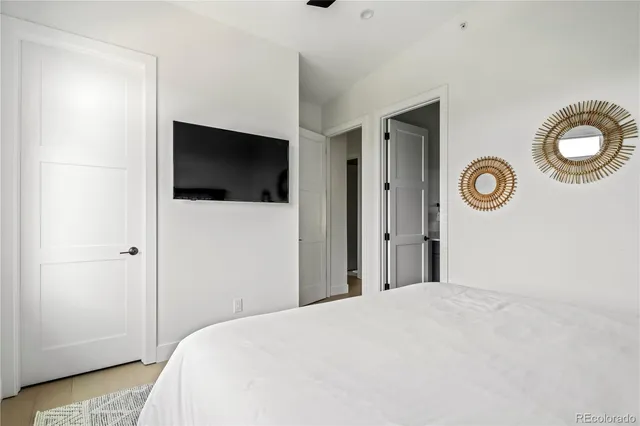 a bedroom with a bed and a television