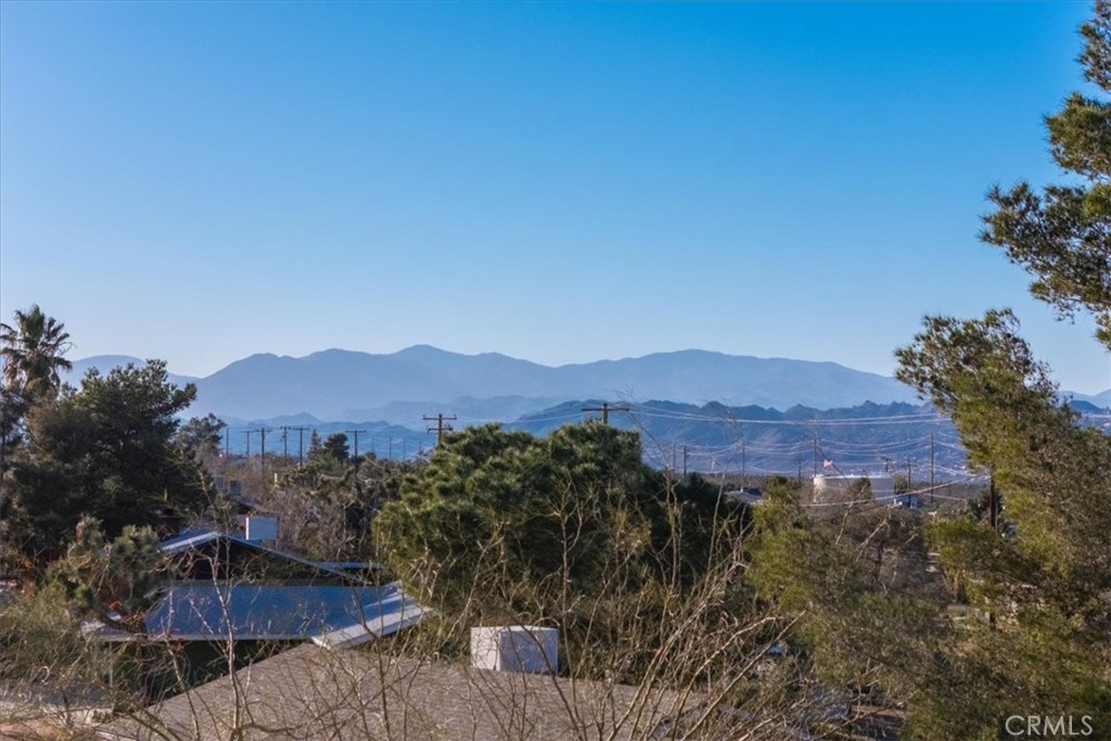 60432 Latham Trail Joshua Tree, CA 92252 - Photo 9 of 25 a view of a street with a mountain in the background