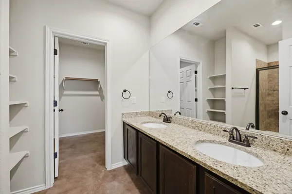 an empty room with windows and ceiling fan