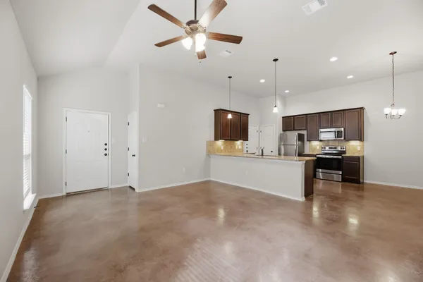 a view of kitchen with kitchen island refrigerator stove microwave and cabinets