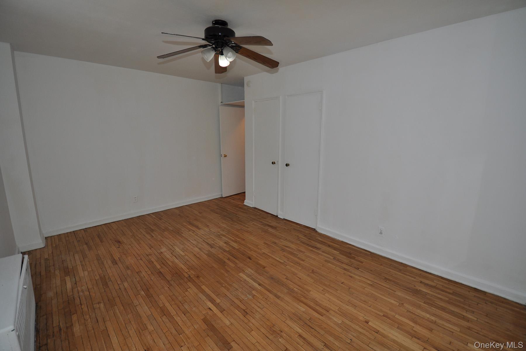 142 Garth Road, Unit 1R Scarsdale, NY 10583 - Photo 10 of 12 a view of empty room with wooden floor