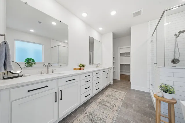 a bathroom with a double vanity sink and a mirror