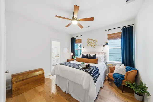 a bedroom with a bed and a chandelier