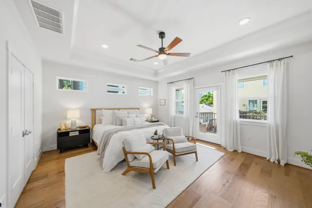 a living room with furniture kitchen view and a chandelier