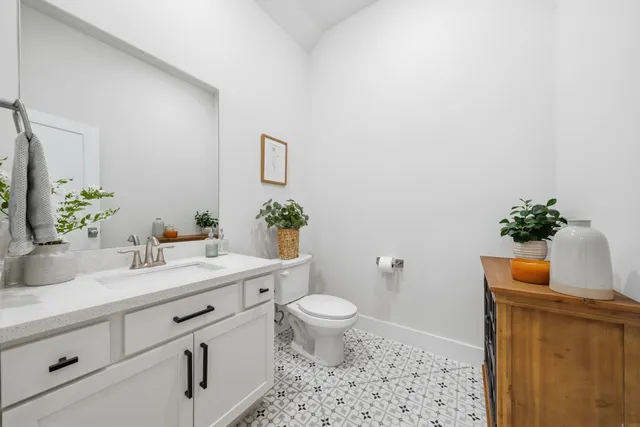 a bathroom with a sink a toilet and a mirror