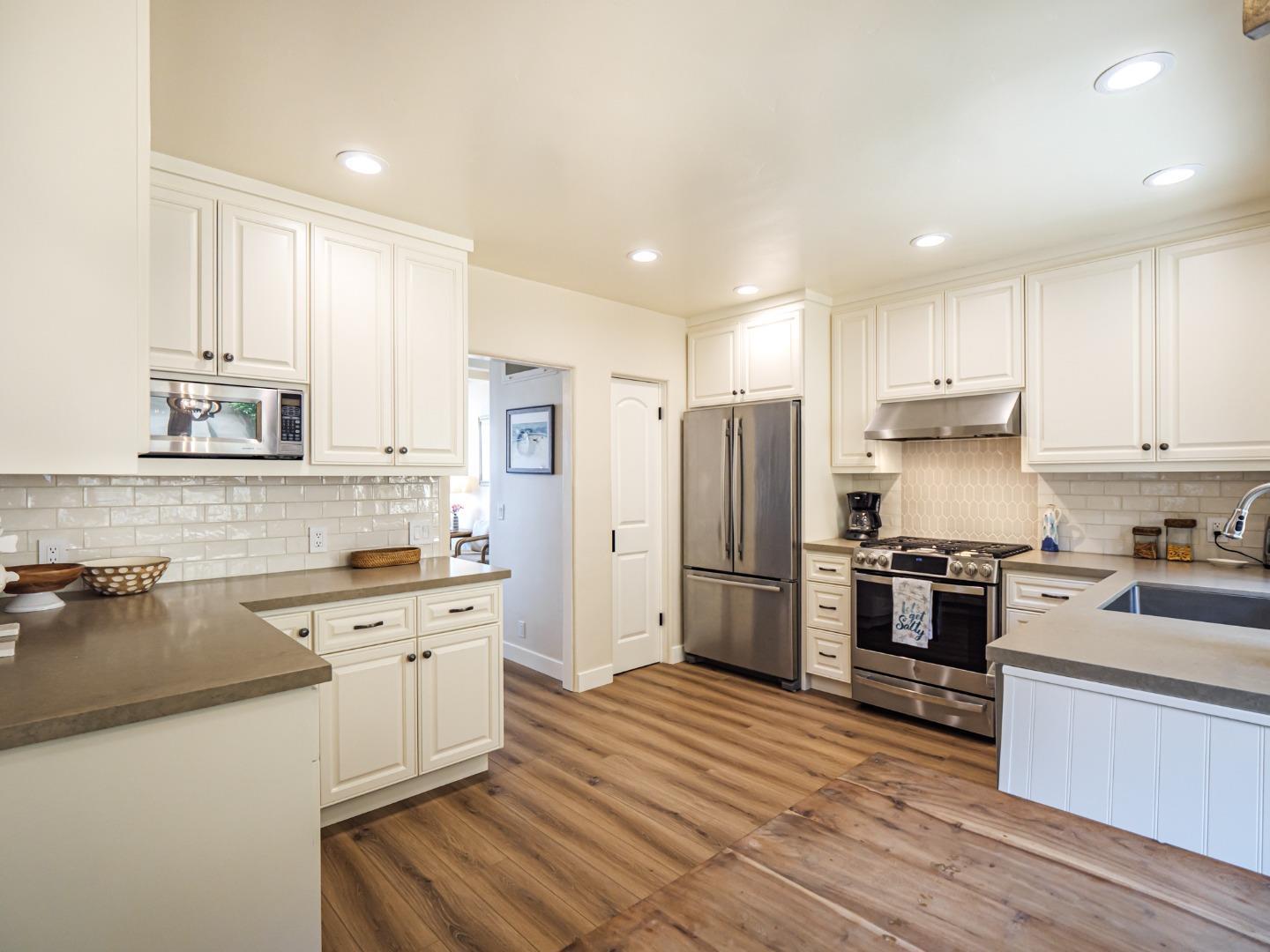 431 Beach Drive Aptos, CA 95003 - Photo 12 of 47 a kitchen with white cabinets stainless steel appliances and sink