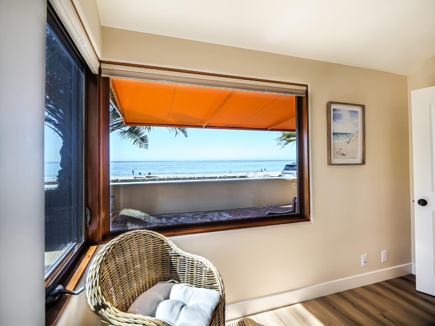 431 Beach Drive Aptos, CA 95003 - Photo 26 of 47 a living room with a couch and floor to ceiling windows