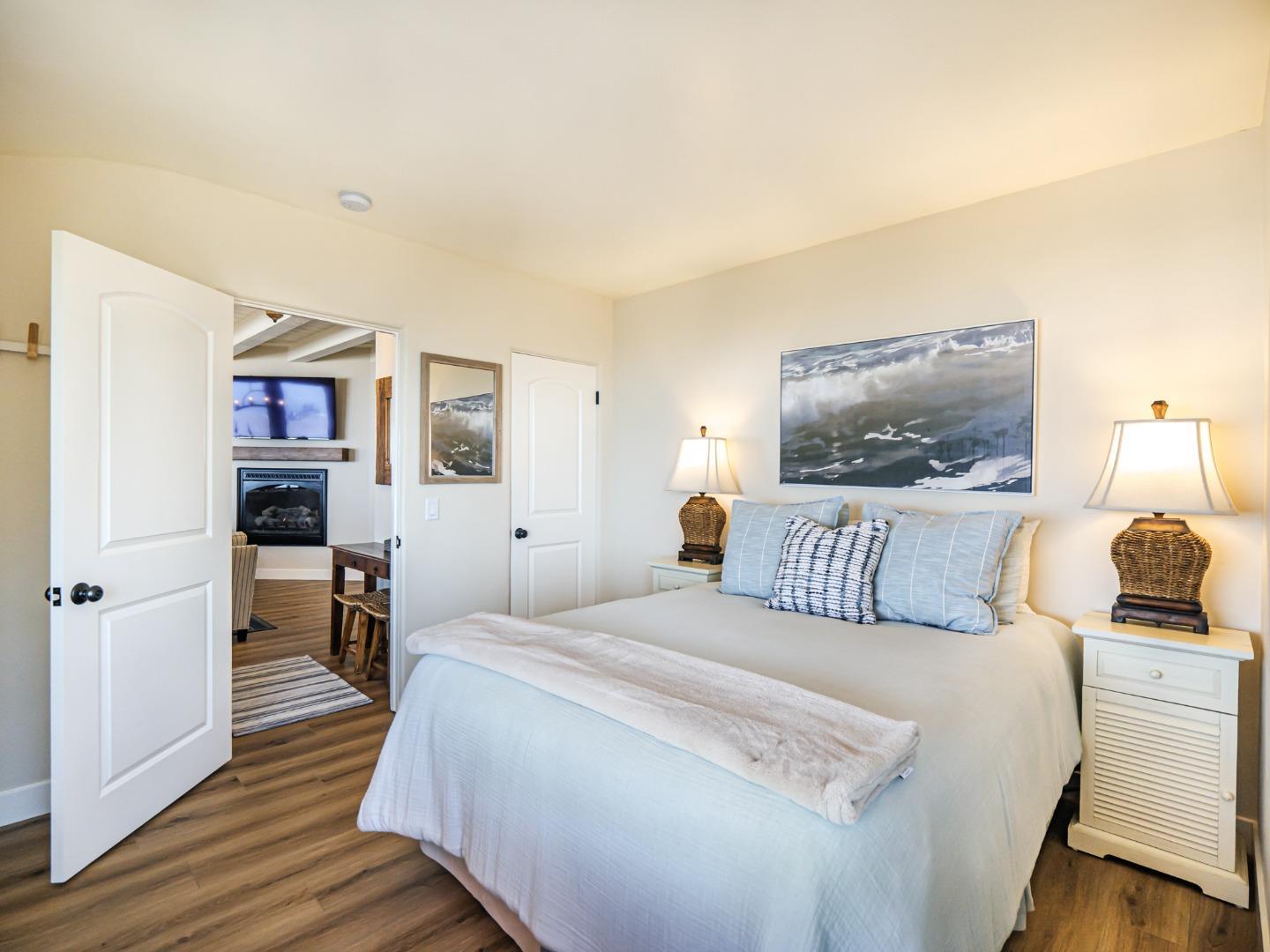 431 Beach Drive Aptos, CA 95003 - Photo 27 of 47 a bedroom with a bed and wooden floor