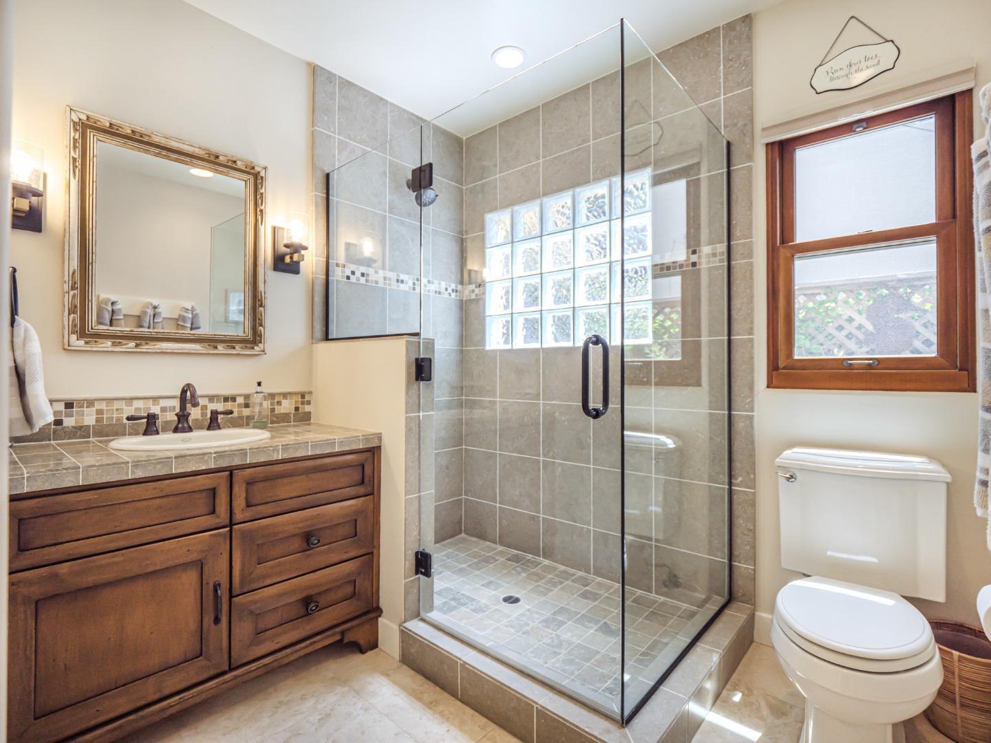 431 Beach Drive Aptos, CA 95003 - Photo 29 of 47 a bathroom with a granite countertop sink toilet and shower