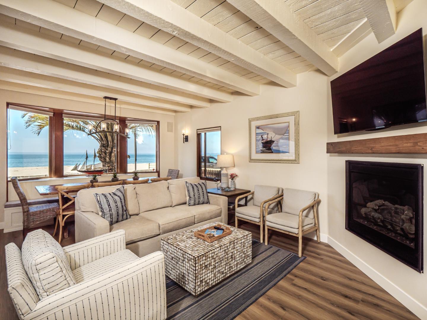 431 Beach Drive Aptos, CA 95003 - Photo 6 of 47 a living room with furniture a flat screen tv and a fireplace