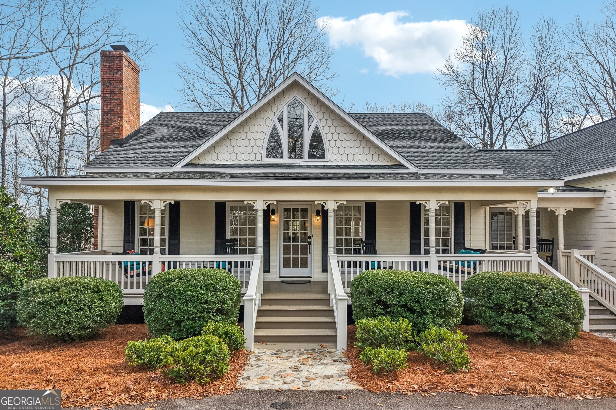 a front view of a house with a garden