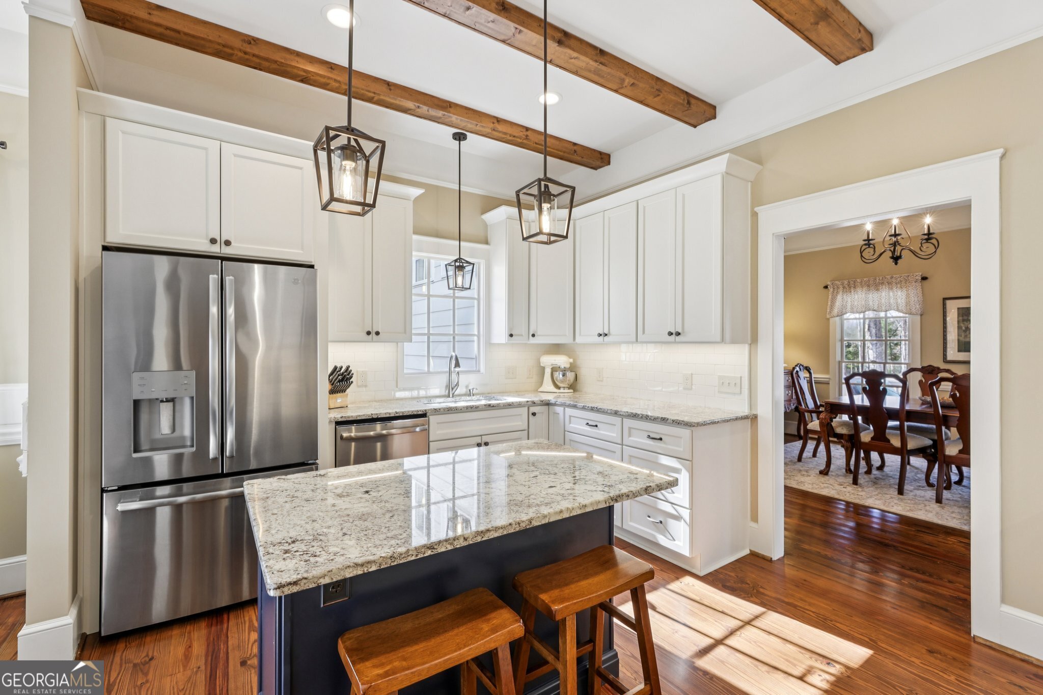 1015 Adams Road West Point, GA 31833 - Photo 17 of 108 a kitchen with granite countertop a refrigerator a stove a sink and white cabinets with wooden floor