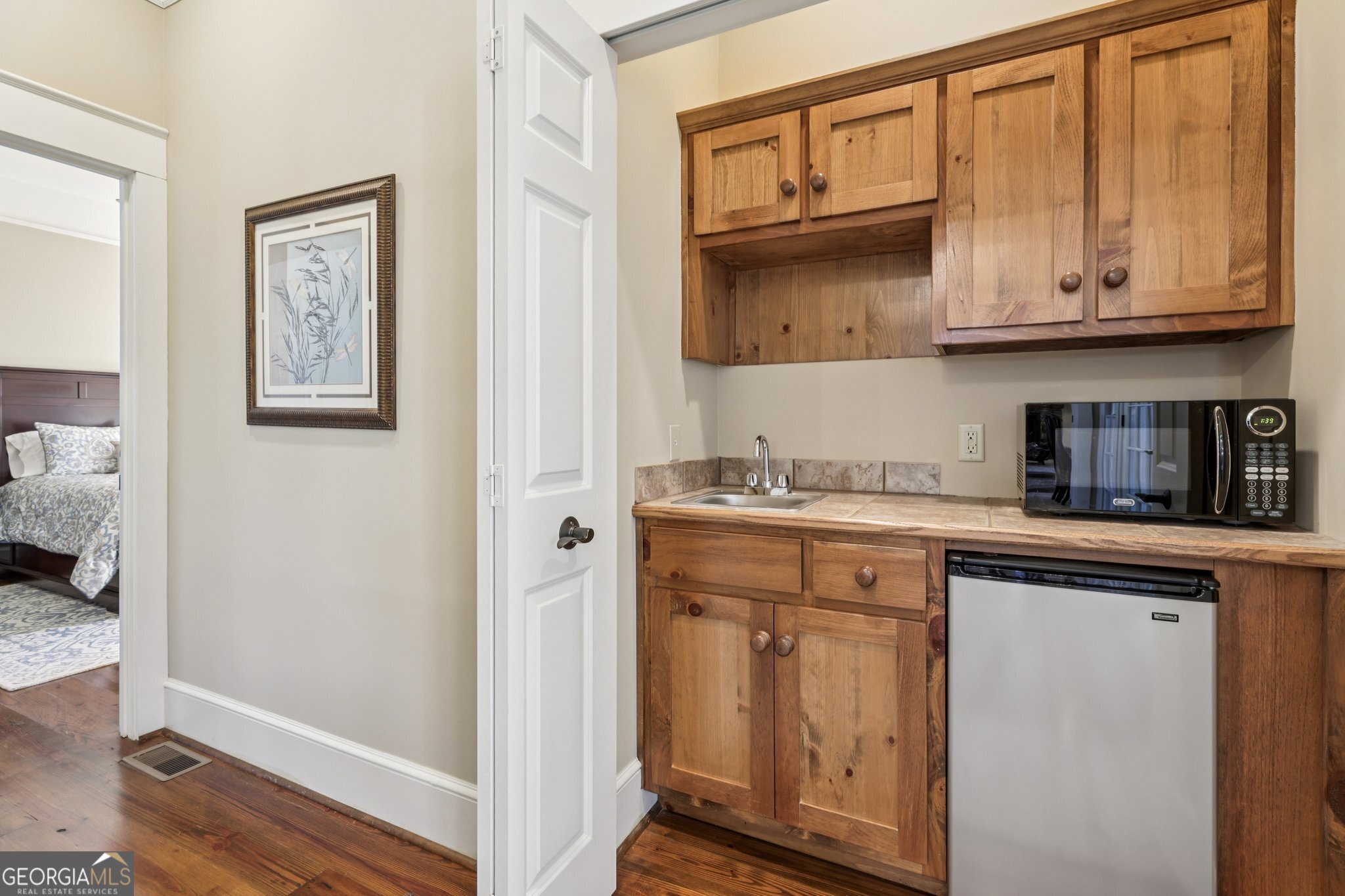 1015 Adams Road West Point, GA 31833 - Photo 44 of 108 a view of cabinets with wooden floor and cabinets