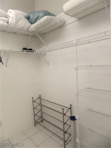 a room with a couch and a refrigerator in it