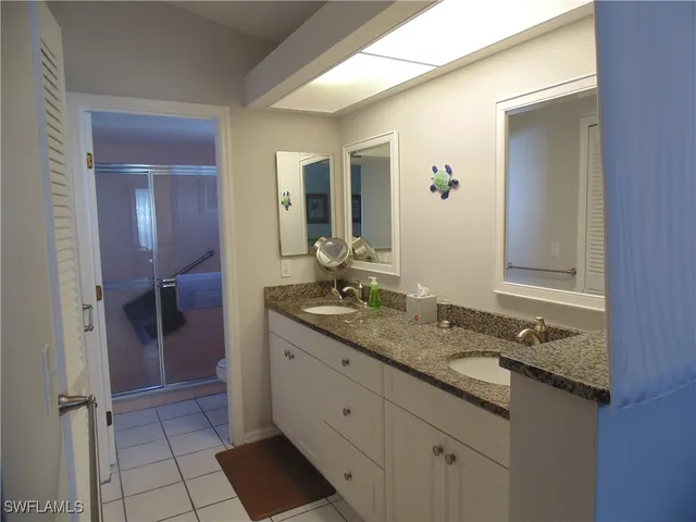 a bedroom with bed and wooden floor