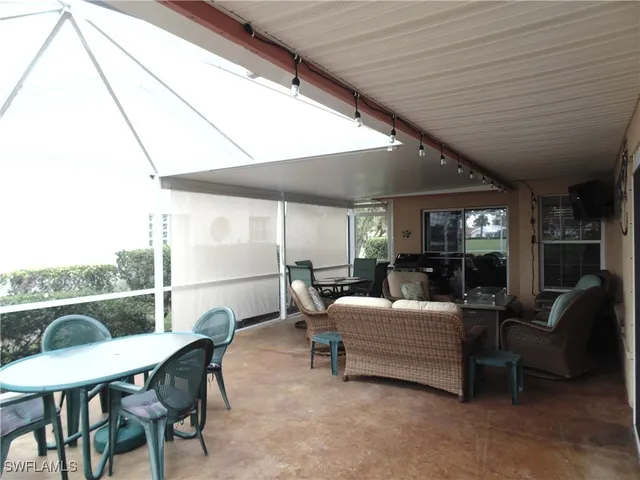 a living room with furniture a window and kitchen view
