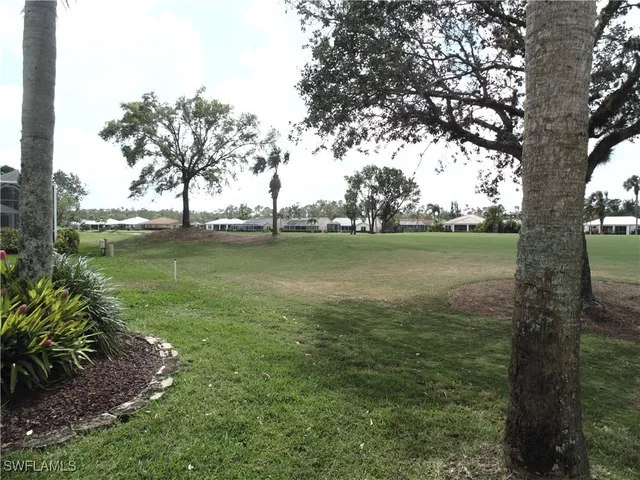 a view of yard with swimming pool and green space