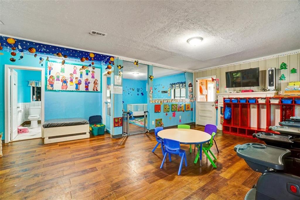 5099 Austell Powder Springs Road Southwest Austell, GA 30106 - Photo 11 of 38 a living room with furniture and a flat screen tv