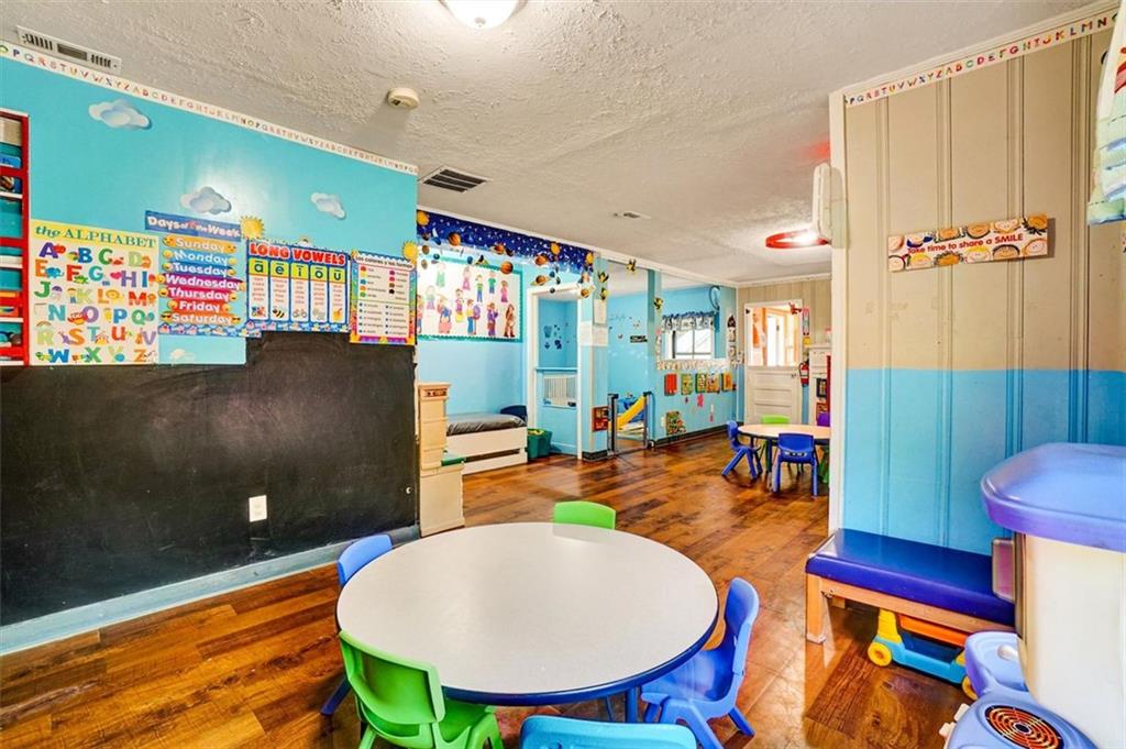 5099 Austell Powder Springs Road Southwest Austell, GA 30106 - Photo 12 of 38 a living room with furniture a rug and a painting