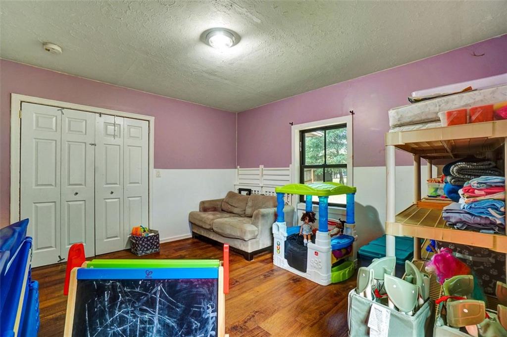 5099 Austell Powder Springs Road Southwest Austell, GA 30106 - Photo 13 of 38 a living room with lots of furniture and a chandelier