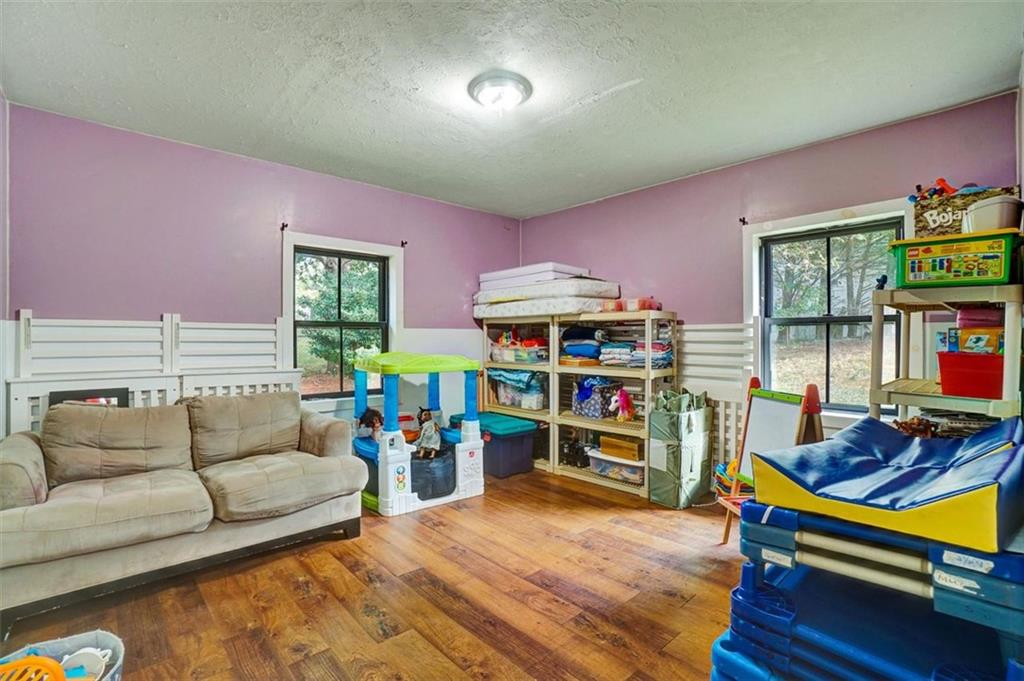5099 Austell Powder Springs Road Southwest Austell, GA 30106 - Photo 14 of 38 a living room with furniture and a wooden floor