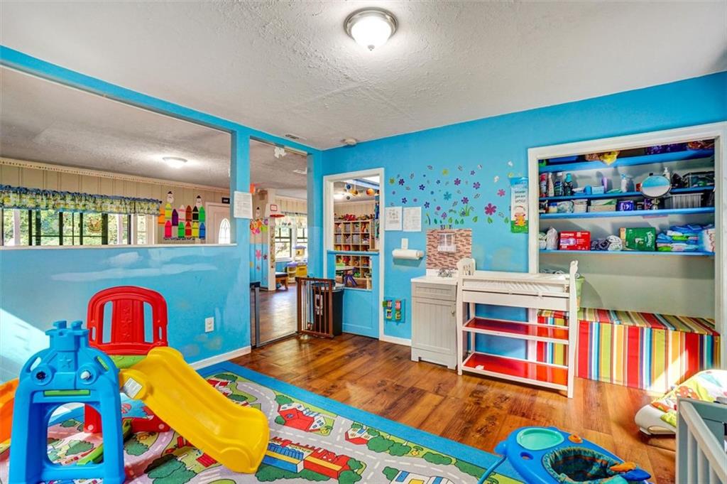 5099 Austell Powder Springs Road Southwest Austell, GA 30106 - Photo 18 of 38 a living room filled with furniture and toys