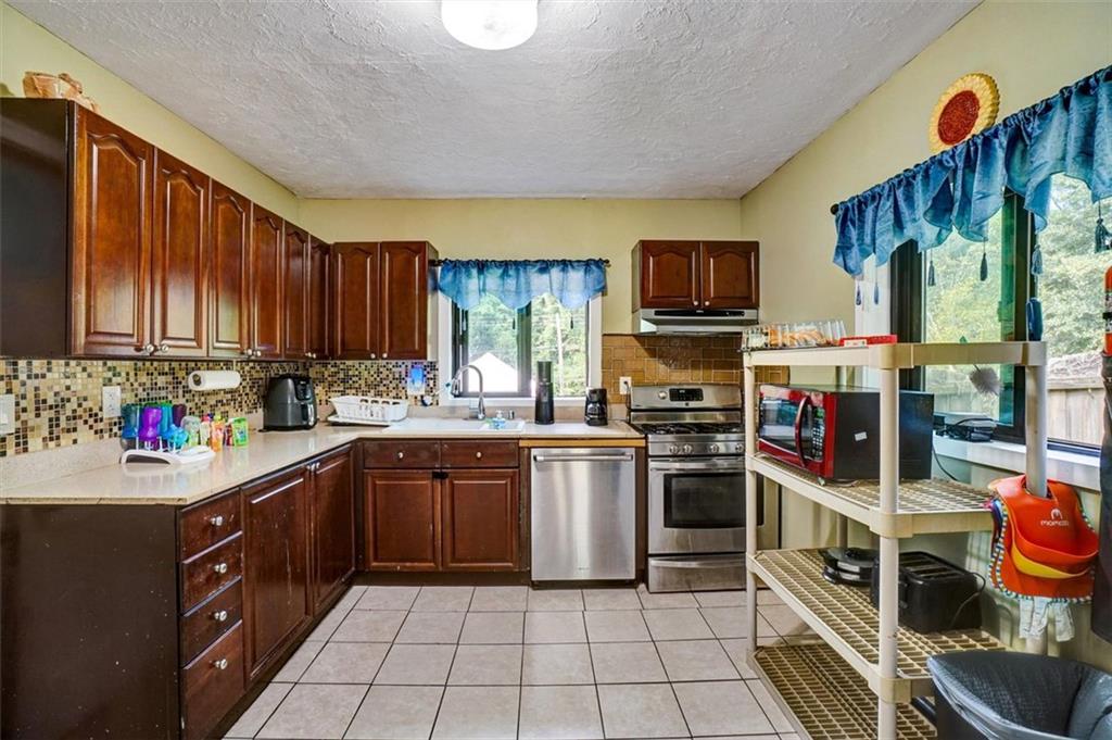 5099 Austell Powder Springs Road Southwest Austell, GA 30106 - Photo 19 of 38 a kitchen with a stove top oven sink and cabinets