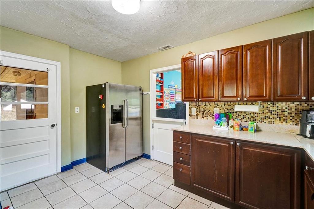 5099 Austell Powder Springs Road Southwest Austell, GA 30106 - Photo 20 of 38 a kitchen with refrigerator and cabinets