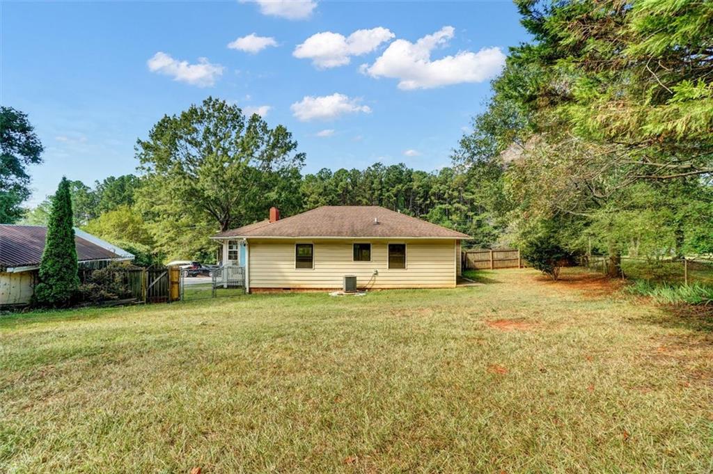 5099 Austell Powder Springs Road Southwest Austell, GA 30106 - Photo 30 of 38 a white house that has a tree in front of it
