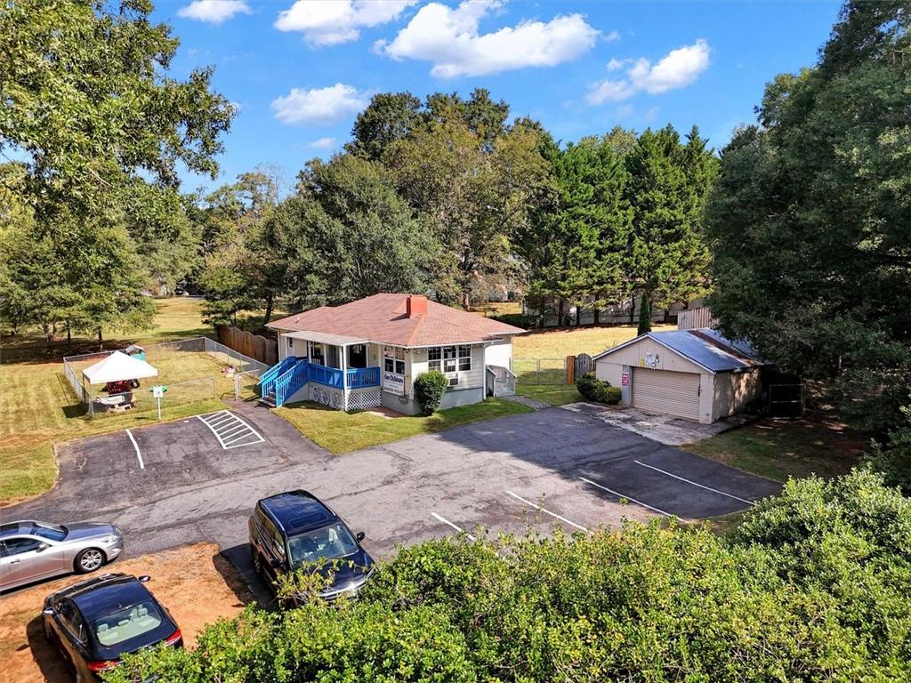 5099 Austell Powder Springs Road Southwest Austell, GA 30106 - Photo 33 of 38 an aerial view of a house with garden space and trees