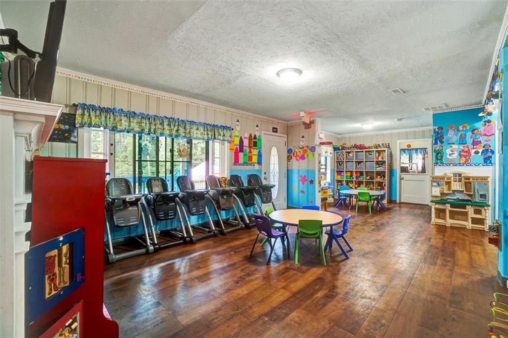 5099 Austell Powder Springs Road Southwest Austell, GA 30106 - Photo 6 of 38 a view of a dining room with furniture and wooden floor