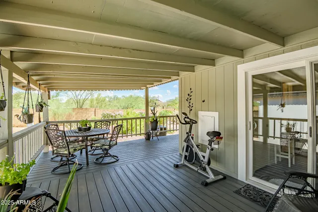 a view of a patio with table and chairs and wooden floor
