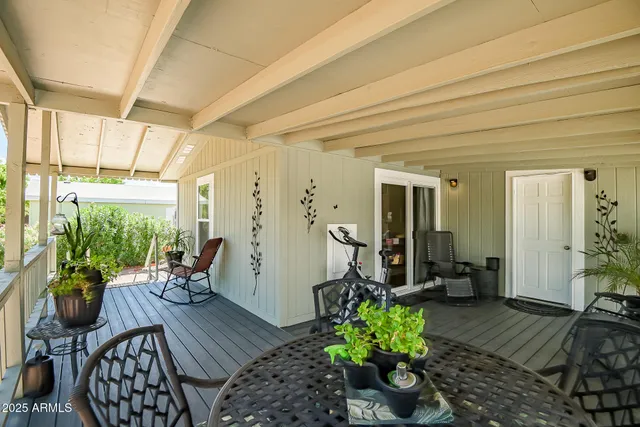 a view of a patio with chairs potted plants